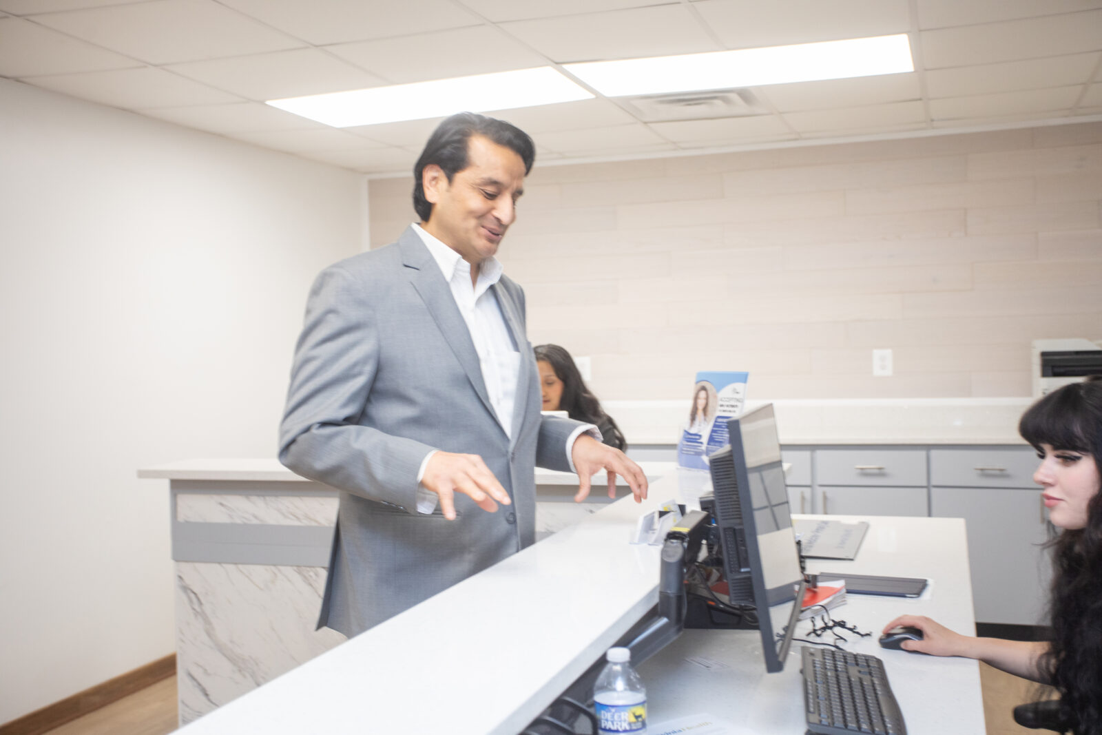 Dr. Mamta Ojha and the Norvinia Health care team at the front desk of the Fairfax, VA office
