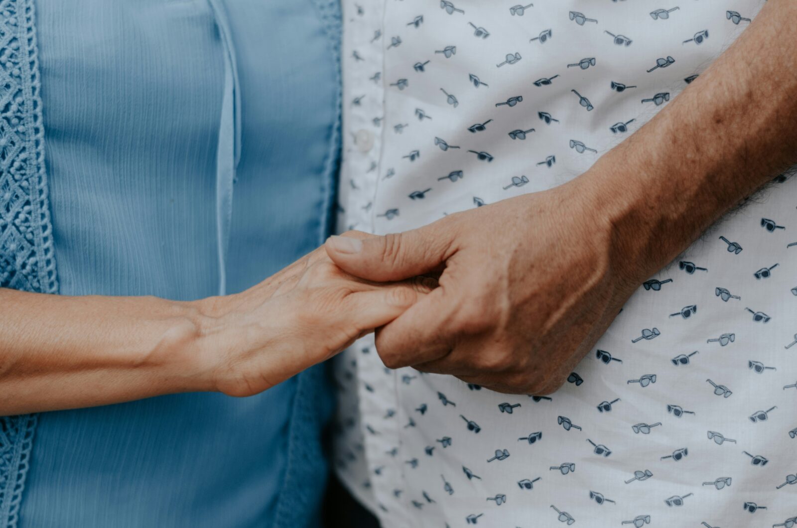 Primary Care Hearing Loss: Causes, Screening, and Treatment Options 7 Older couple holding hands representing age-related hearing loss care in Fairfax