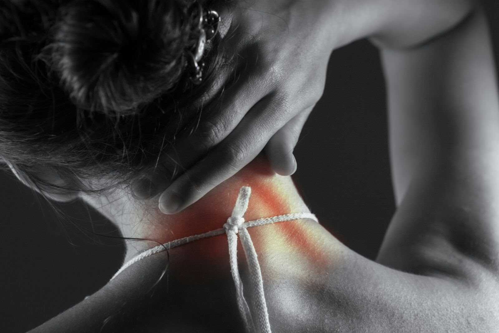 Hand at neck representing hyperthyroidism treatment Fairfax care