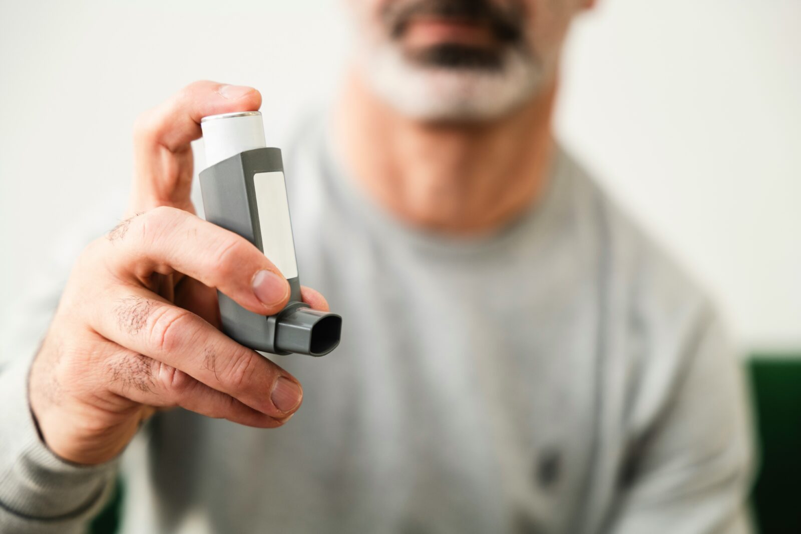 Primary Care Asthma: Symptoms, Triggers, and Long-Term Control 8 Man using a rescue inhaler to control asthma symptoms